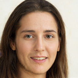 Joyful white young-adult female with long  brown hair and green eyes