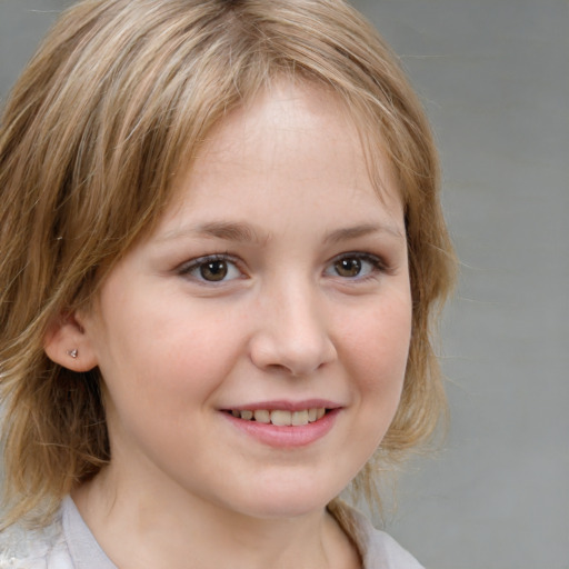 Joyful white child female with medium  brown hair and brown eyes