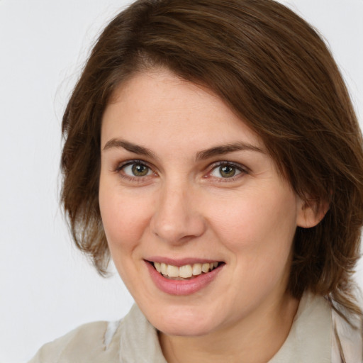 Joyful white young-adult female with medium  brown hair and green eyes