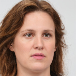 Joyful white young-adult female with long  brown hair and green eyes