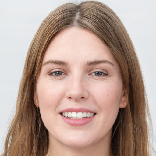 Joyful white young-adult female with long  brown hair and grey eyes