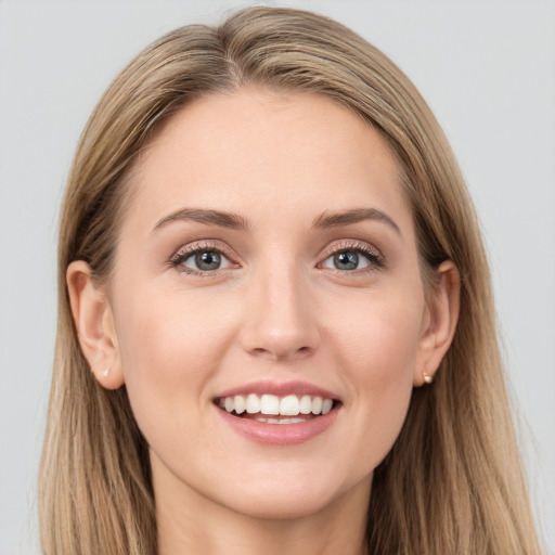 Joyful white young-adult female with long  brown hair and grey eyes