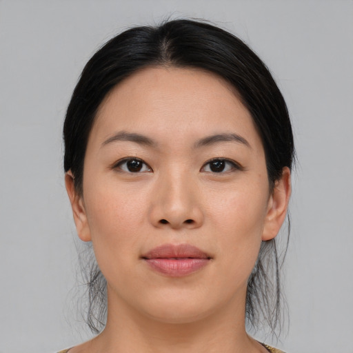 Joyful asian young-adult female with medium  black hair and brown eyes