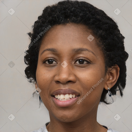 Joyful black young-adult female with medium  black hair and brown eyes