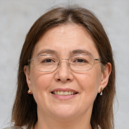 Joyful white adult female with medium  brown hair and grey eyes