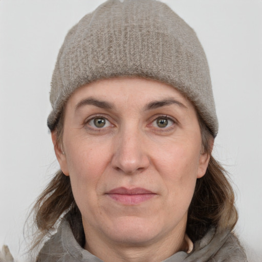 Joyful white adult female with medium  brown hair and grey eyes