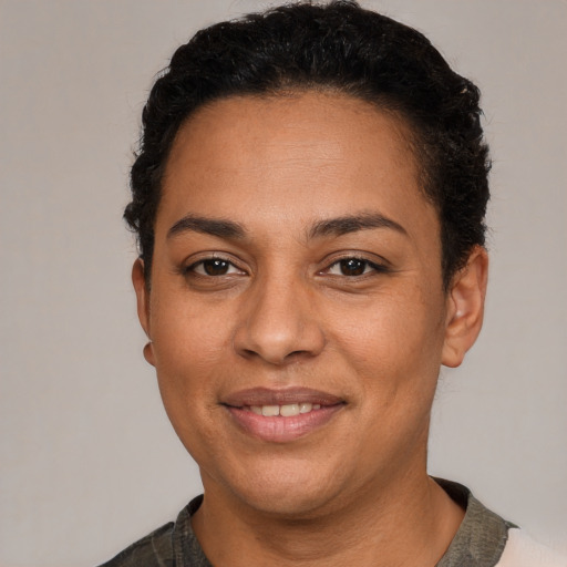 Joyful latino adult female with short  black hair and brown eyes