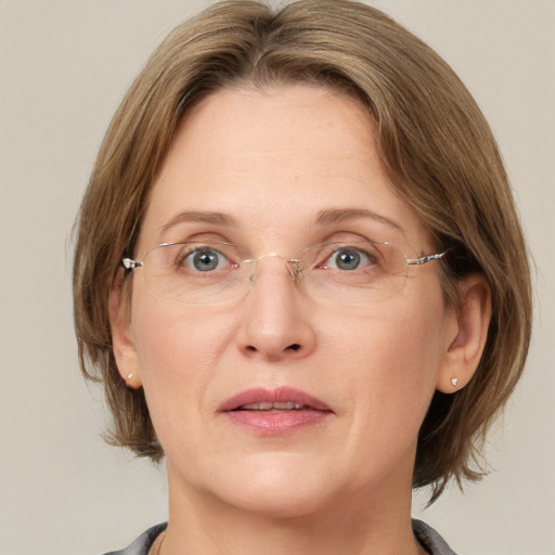 Joyful white adult female with medium  brown hair and grey eyes