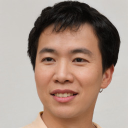 Joyful asian young-adult male with short  brown hair and brown eyes