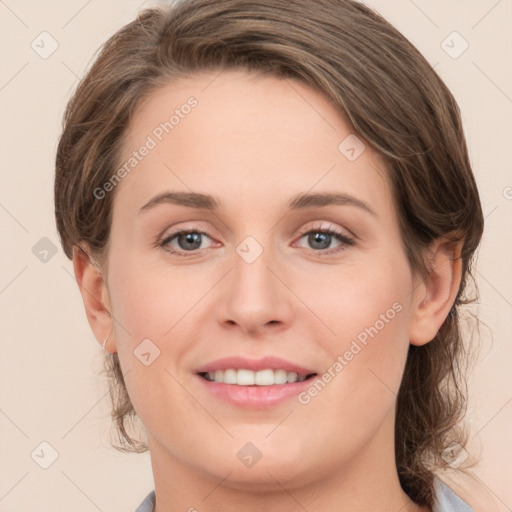 Joyful white young-adult female with medium  brown hair and green eyes