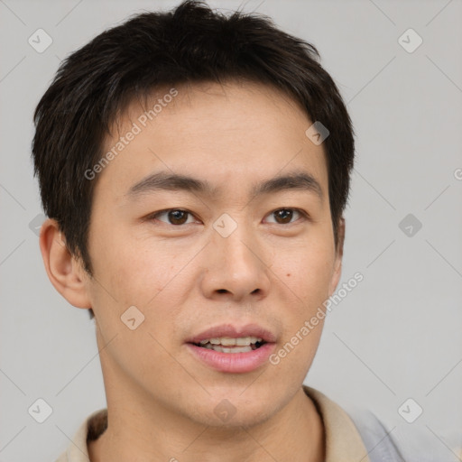 Joyful asian young-adult male with short  brown hair and brown eyes