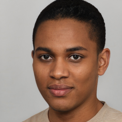 Joyful black young-adult male with short  black hair and brown eyes