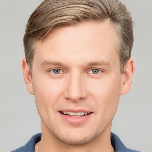 Joyful white young-adult male with short  brown hair and blue eyes