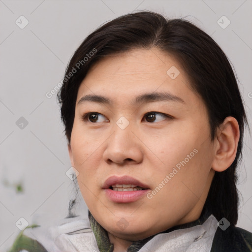 Joyful asian young-adult female with medium  black hair and brown eyes