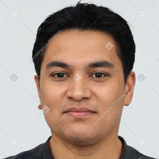 Joyful latino young-adult male with short  black hair and brown eyes