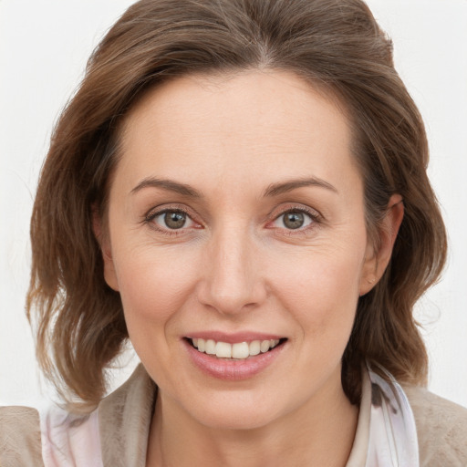 Joyful white young-adult female with medium  brown hair and blue eyes