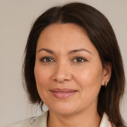 Joyful white adult female with medium  brown hair and brown eyes