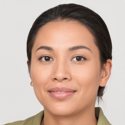 Joyful latino young-adult female with medium  brown hair and brown eyes