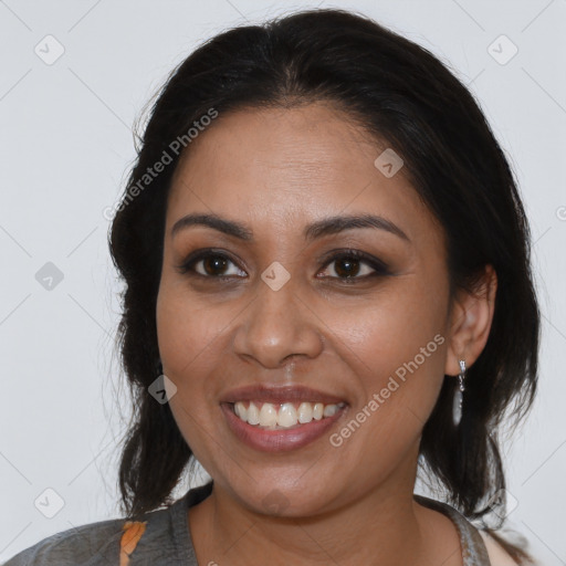 Joyful latino young-adult female with medium  brown hair and brown eyes