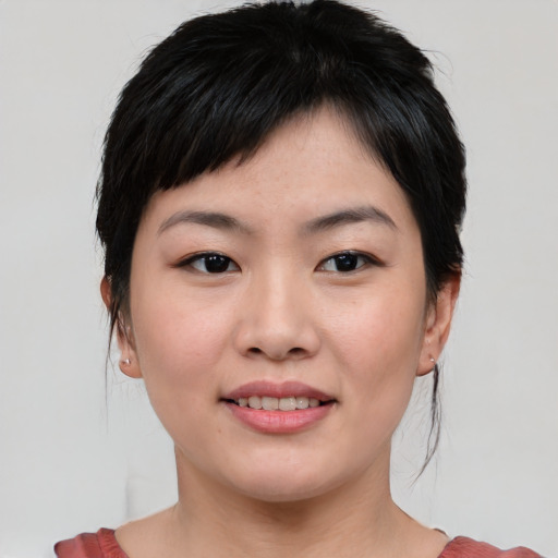 Joyful asian young-adult female with medium  brown hair and brown eyes