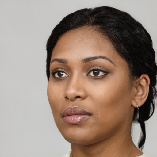 Neutral black young-adult female with medium  black hair and brown eyes