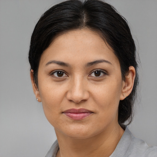Joyful latino young-adult female with medium  brown hair and brown eyes