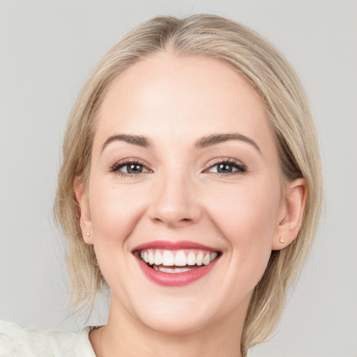 Joyful white young-adult female with medium  brown hair and blue eyes