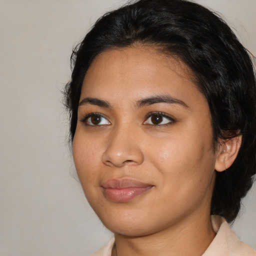 Joyful latino young-adult female with medium  black hair and brown eyes