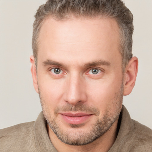 Joyful white adult male with short  brown hair and grey eyes