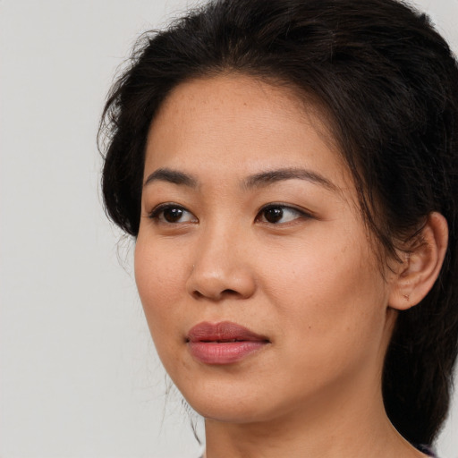 Joyful asian young-adult female with long  brown hair and brown eyes