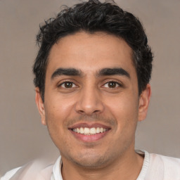 Joyful white young-adult male with short  black hair and brown eyes