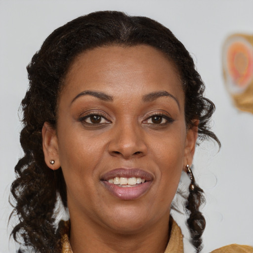 Joyful black adult female with medium  brown hair and brown eyes