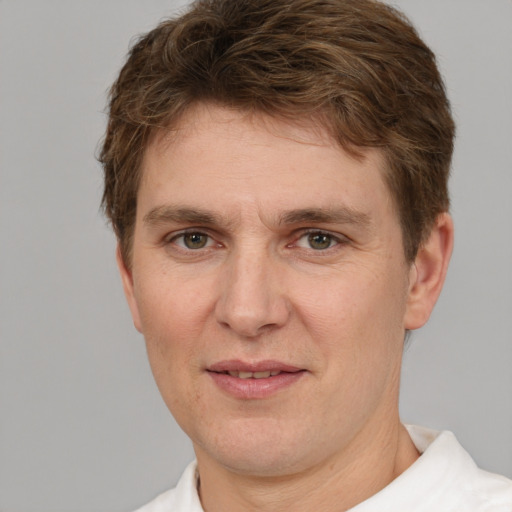 Joyful white adult male with short  brown hair and grey eyes