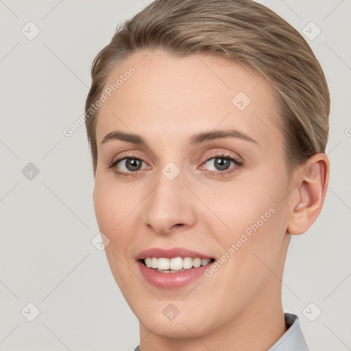 Joyful white young-adult female with short  brown hair and brown eyes