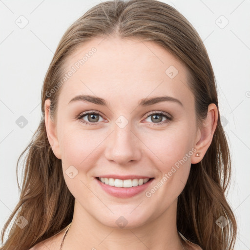 Joyful white young-adult female with long  brown hair and blue eyes