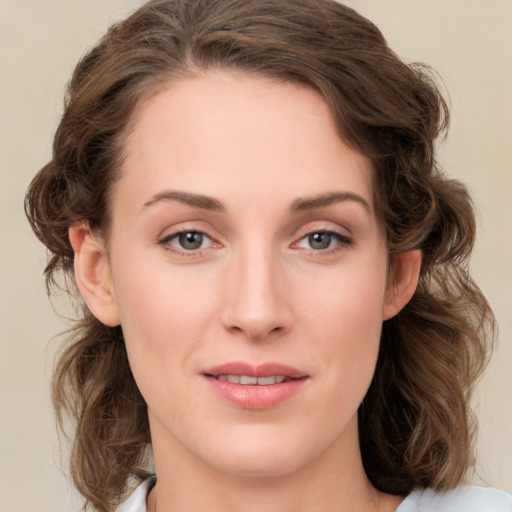 Joyful white young-adult female with medium  brown hair and green eyes