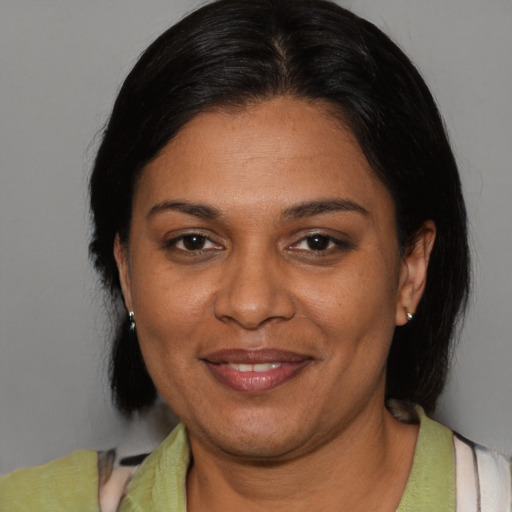 Joyful black adult female with short  brown hair and brown eyes