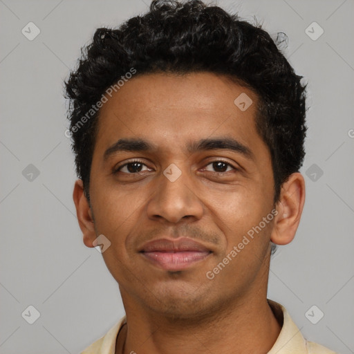 Joyful black young-adult male with short  black hair and brown eyes