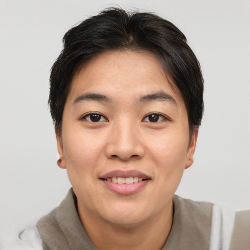 Joyful asian young-adult female with short  brown hair and brown eyes
