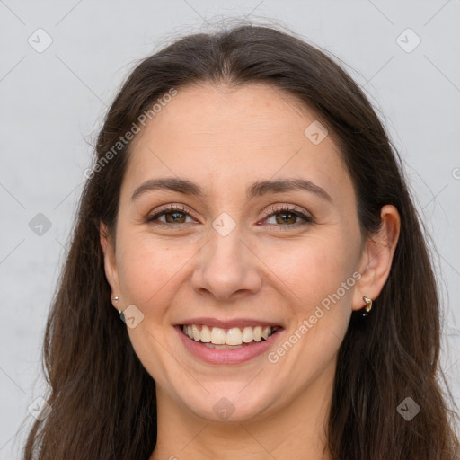 Joyful white adult female with long  brown hair and brown eyes