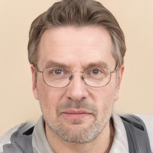 Joyful white middle-aged male with short  brown hair and grey eyes