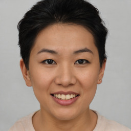 Joyful asian young-adult female with short  brown hair and brown eyes