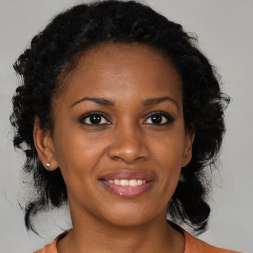 Joyful black young-adult female with medium  brown hair and brown eyes