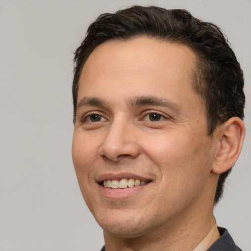 Joyful white adult male with short  brown hair and brown eyes