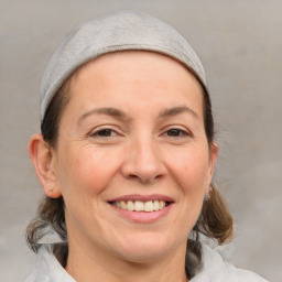 Joyful white adult female with medium  brown hair and brown eyes