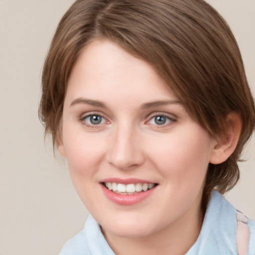 Joyful white young-adult female with medium  brown hair and green eyes