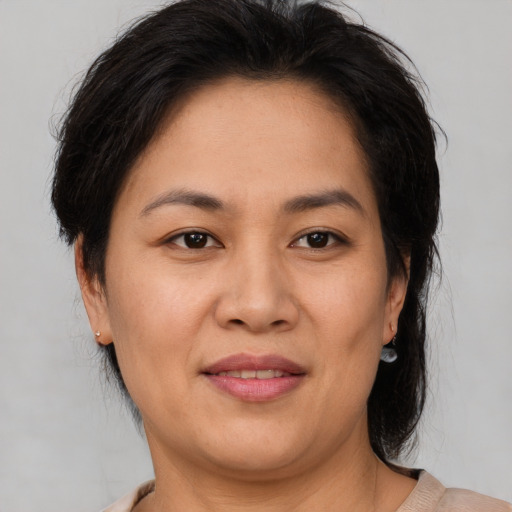 Joyful asian young-adult female with medium  brown hair and brown eyes