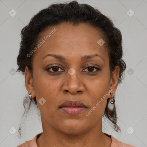 Joyful black adult female with short  brown hair and brown eyes