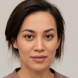 Joyful asian young-adult female with medium  brown hair and brown eyes