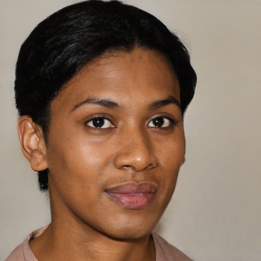 Joyful black young-adult female with short  black hair and brown eyes